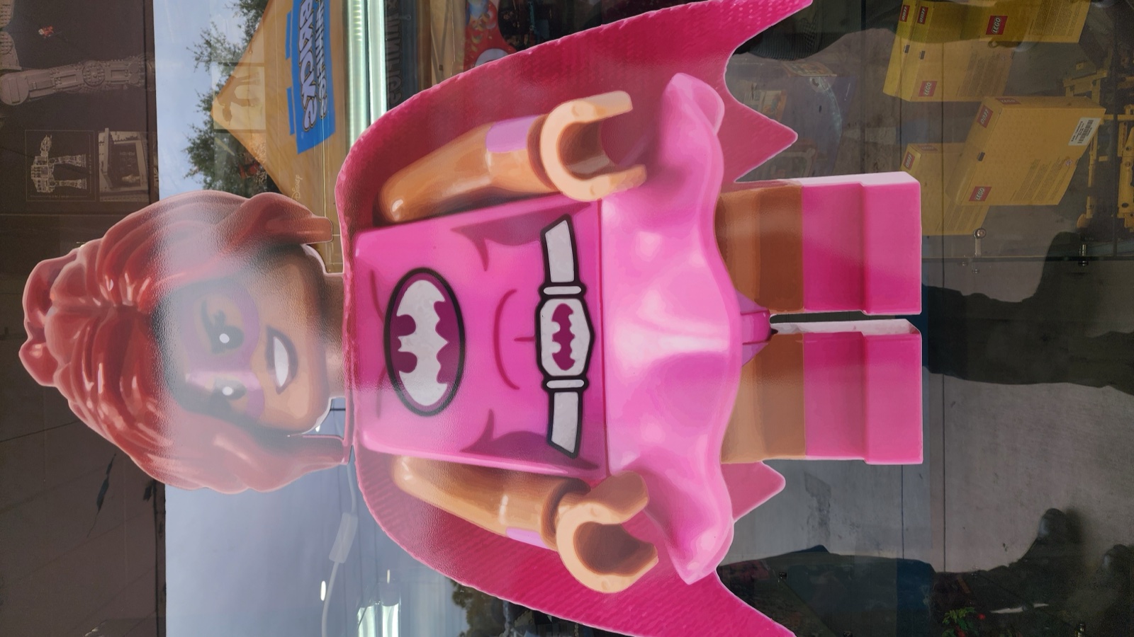 Pink Batgirl minifigure statue greeting customers