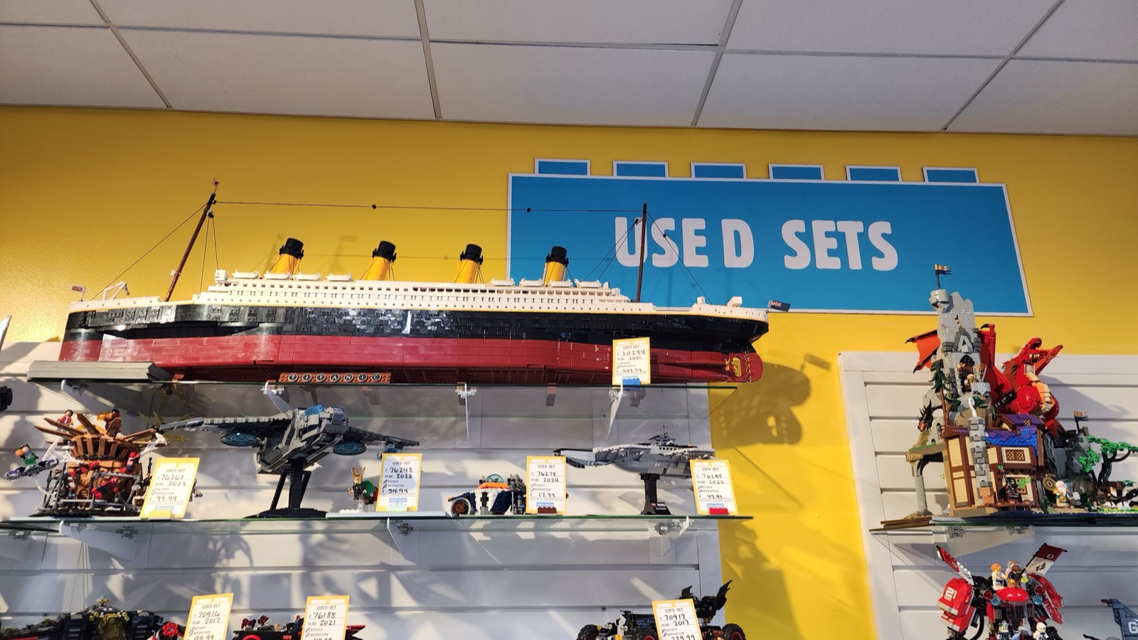 The built LEGO Titanic sits proudly on the top shelf under the Used Sets sign